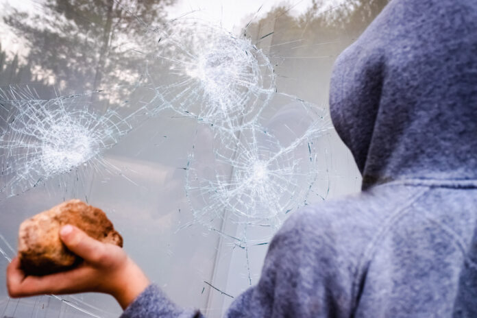 Showcase,With,Broken,Glass,During,A,Protest,In,A,City