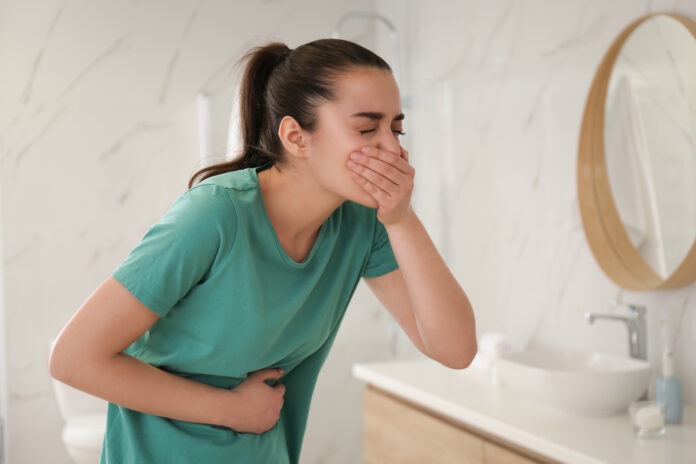 Young,Woman,Suffering,From,Nausea,In,Bathroom.,Food,Poisoning