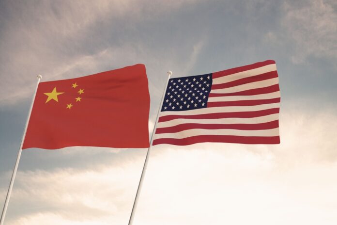 Flags,Of,China,And,Usa,Waving,With,Cloudy,Blue,Sky
